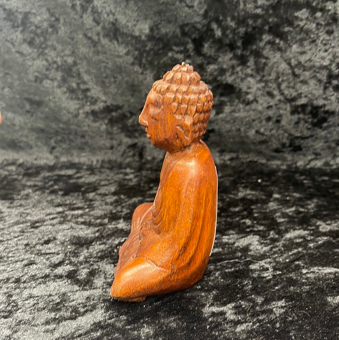 Wooden meditating figurines