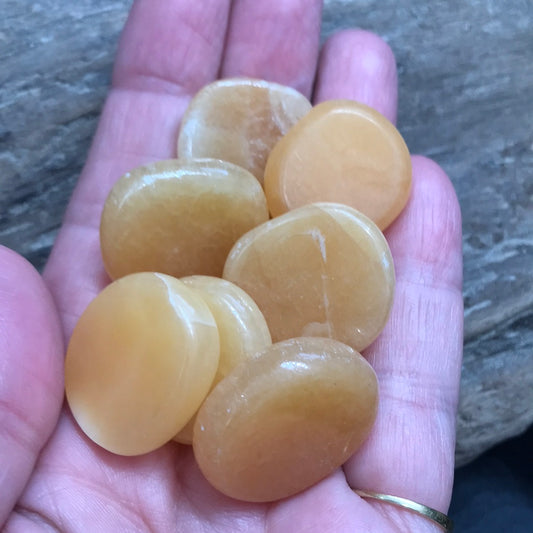 Orange calcite disk palms stone - small